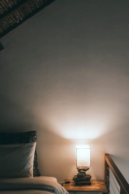 Lamp On Bedside Table In Cozy Bedroom